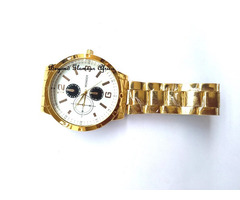 Gold tone watch with white face