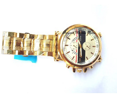 Gold tone watch with white chronograph face